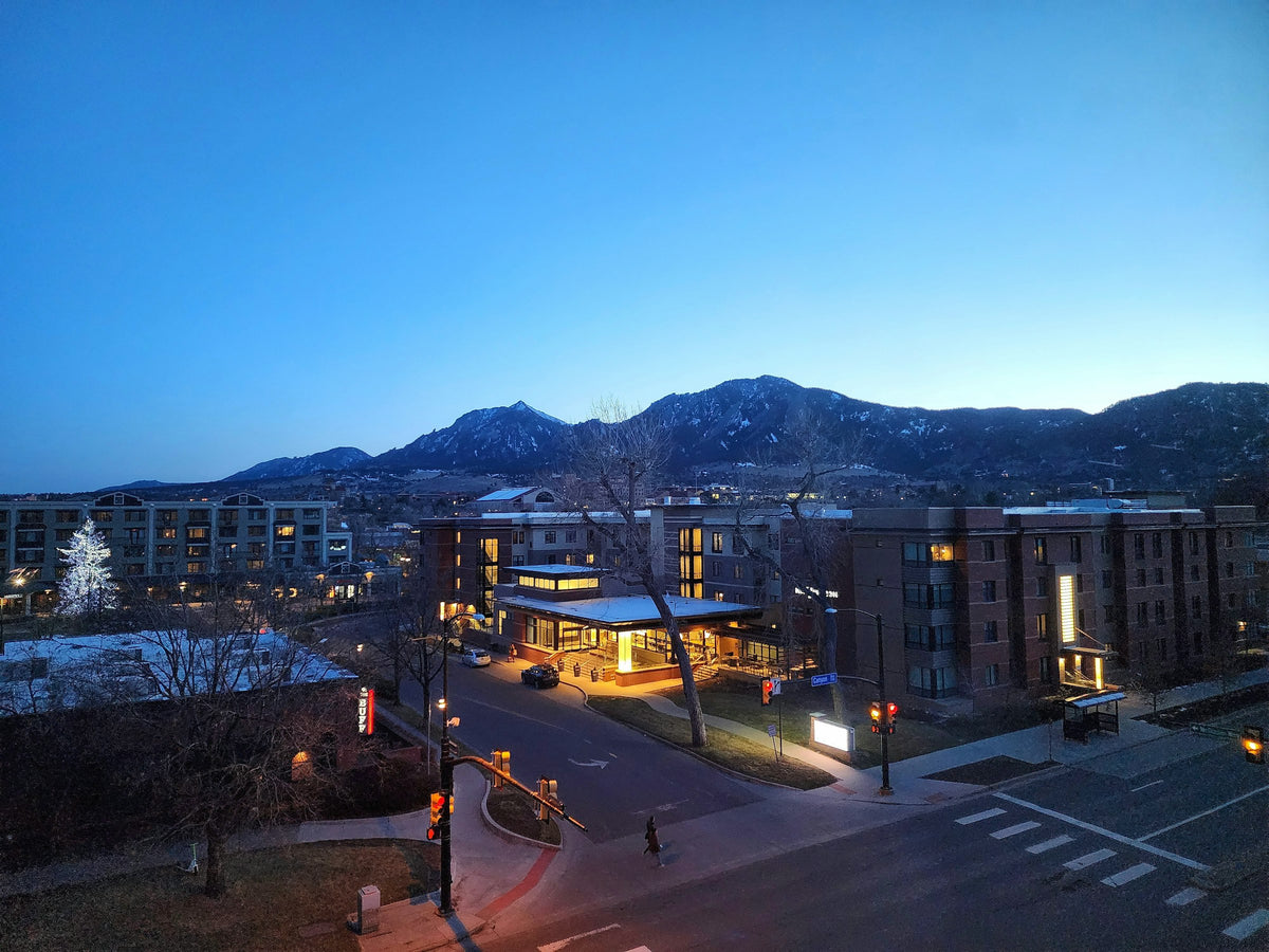Boulder at night with the mountains behind